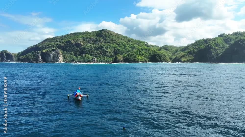 Small fishing boat floating on tropical sea
Small fishing boat floating on tropical sea