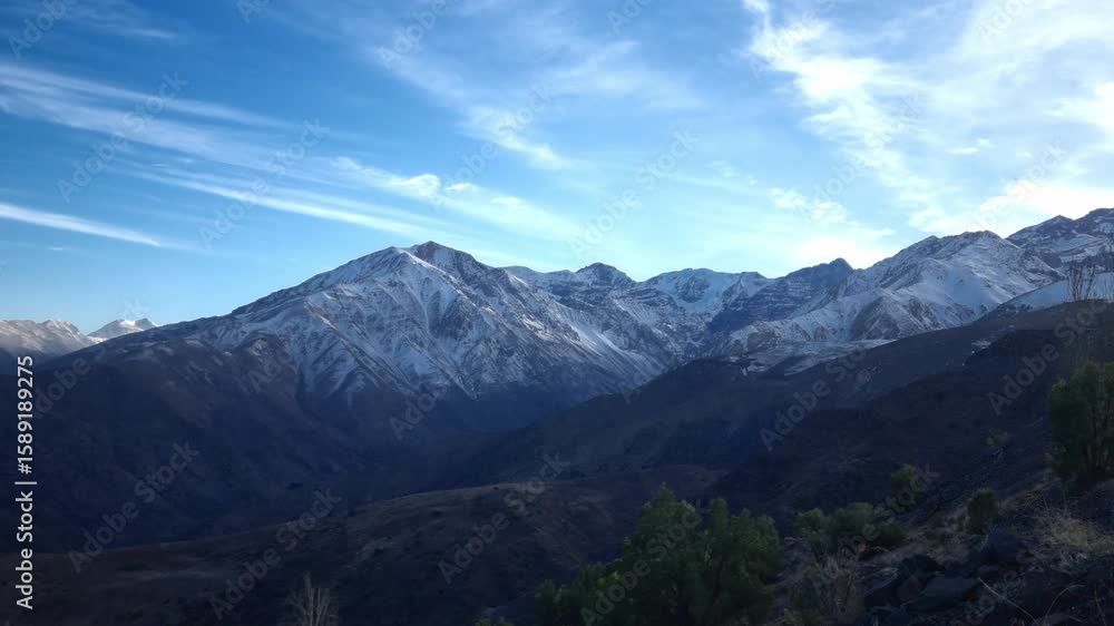 Scenic image of Chile’s Andes Mountains, covered in snow and set against a blue sky with light clouds. Scenic image of Chile’s Andes Mountains, covered in snow and set against a blue sky with light clouds.