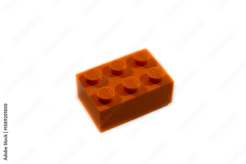 Fototapeta premium Miercurea Ciuc, Romania- 17 July 2025: Orange Lego brick on white background.