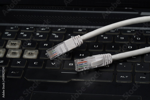 ethernet internet cat6 lan white cable close up shot on dark theme background 