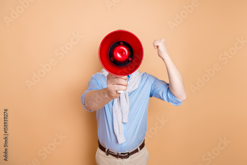Cuadro en lienzo Man with a bright red megaphone gesturing confidently against beige background,