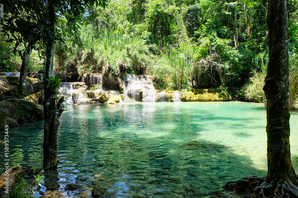 Naklejka premium Most magnificent and breathtaking nature of Kuang Si waterfall and cascade and its green, emerald crystal clear water and lake in Luang Prabang 