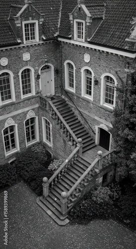 Exterior view of a grand stone mansion with stairs