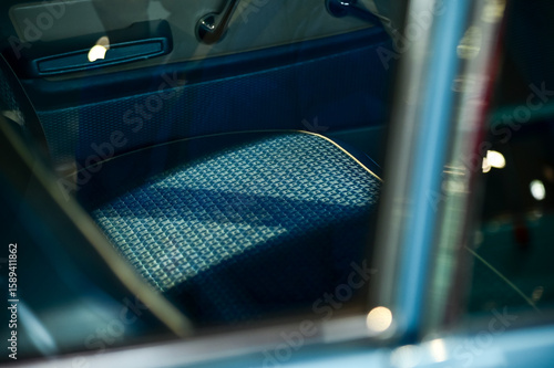 Detail of the interior of a vintage car. Retro car. Close-up of the old steering wheel, console, seats, insides of the  retro car. Interior of a classic vintage car