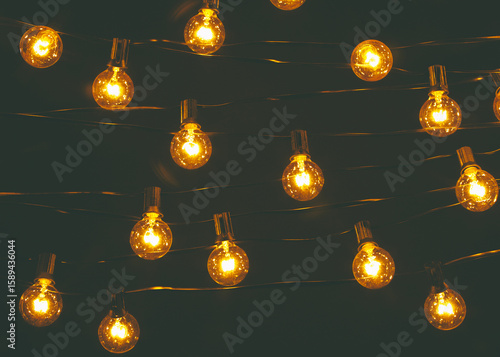 Background - electric garland with incandescent bulbs, yellow warm light