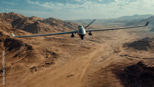 A large military drone glides effortlessly across a vast desert, wings fully extended against the endless sandy hills