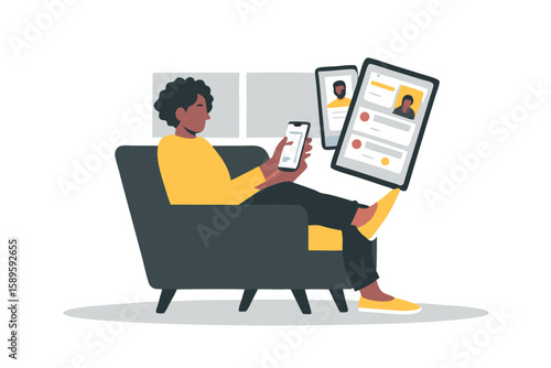 African American woman relaxes on a gray armchair using a smartphone and tablet Digital communication modern lifestyle