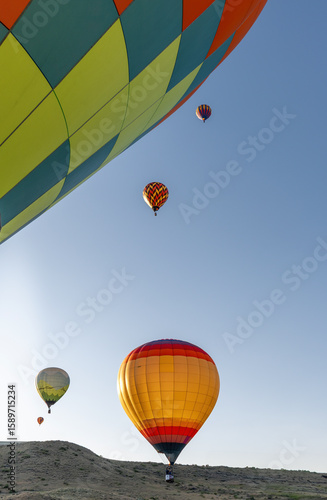 A group of hot air balloons are flying in the sky