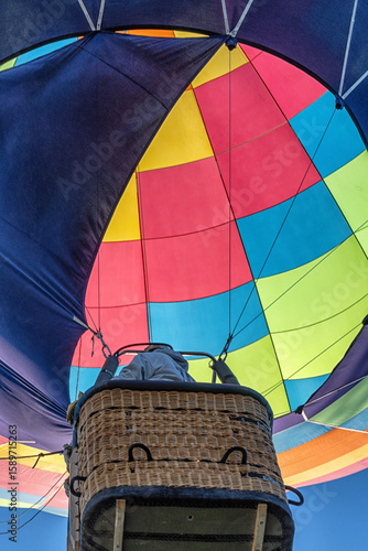 A colorful hot air balloon with a man inside