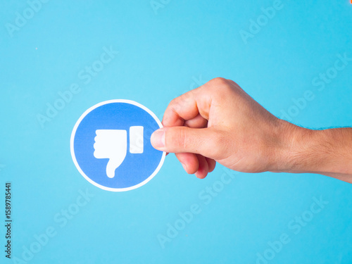 Online disapproval: human hand holding a 