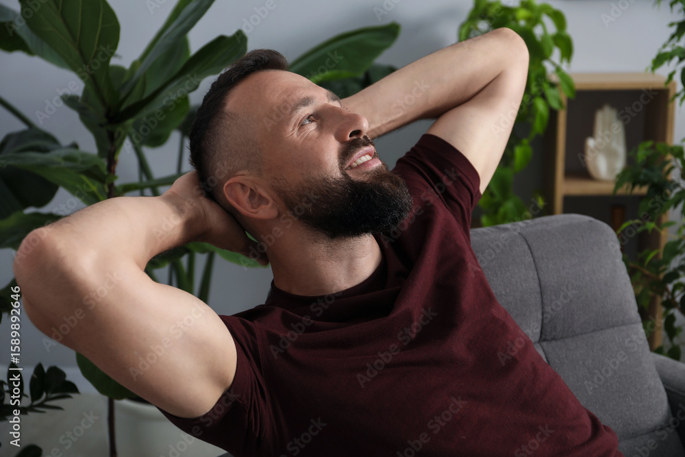 Fototapeta premium Harmony. Man relaxing in comfortable armchair at home