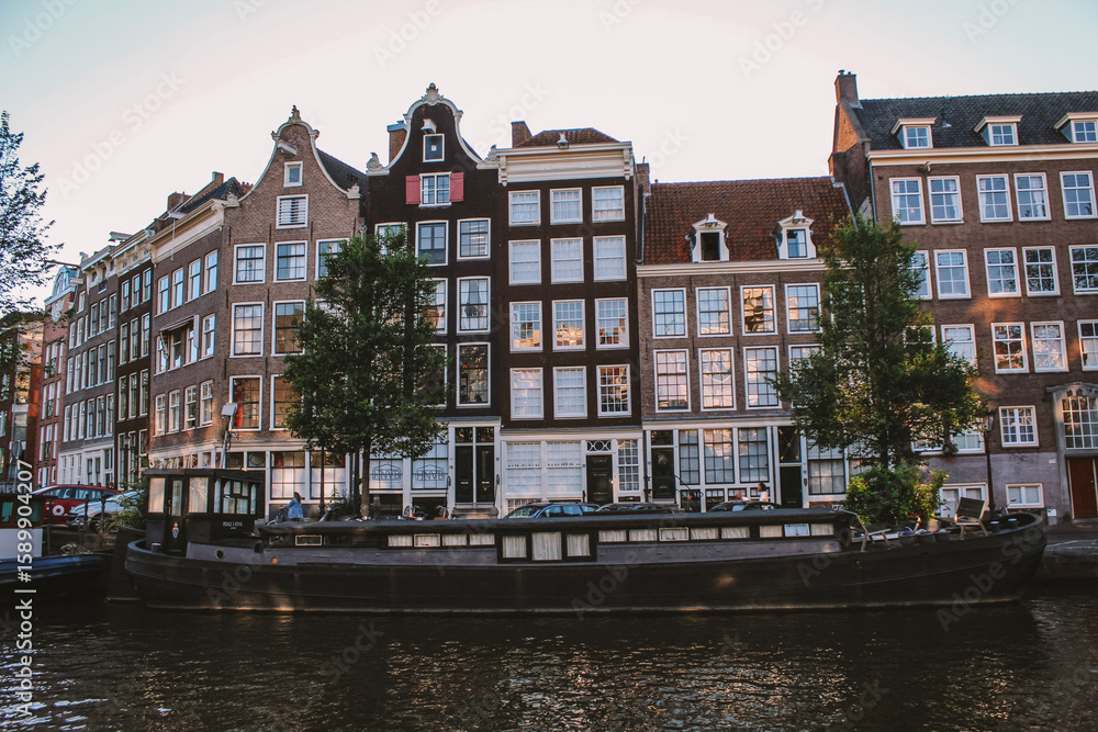 Amsterdam canal houses with a boat Amsterdam canal houses with a boat