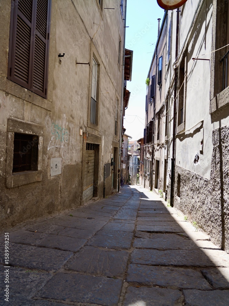 Fototapeta premium Narrow street in the Medieval old town of Viterbo. Viterbo, Lazio region, Italy