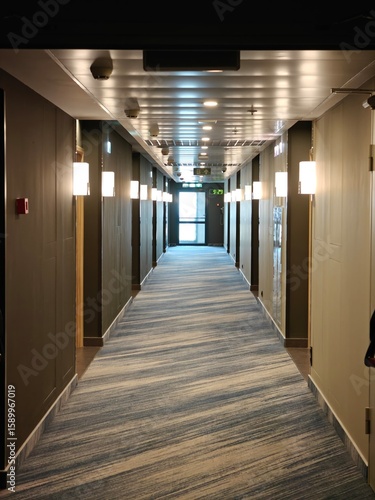 Long corridor with modern lighting in a hotel during the day showcasing elegant design elements