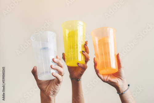 Many different hands holding glass