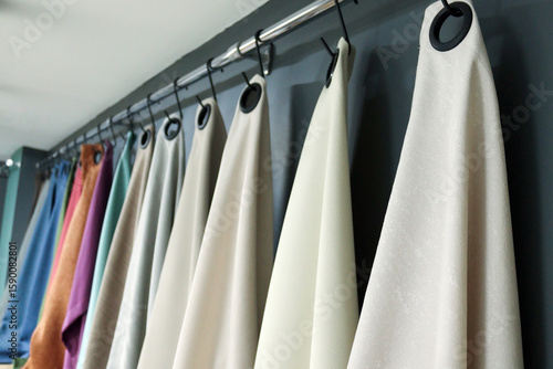 curtain samples hanging on a showroom rail