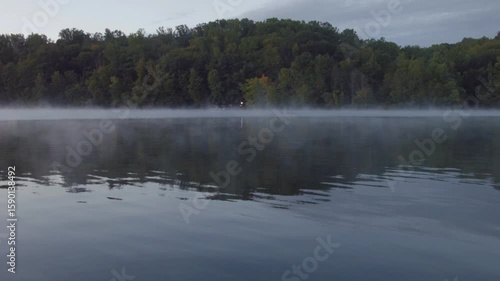 mist hangs over water in early morning