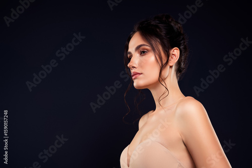 фотографія Charming brunette woman in glamorous lingerie with stylish hairdo posing against