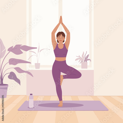 Woman practicing yoga tree pose on mat in a bright room with plants