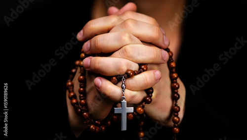 assumption day | Hands holding rosary beads with cross praying