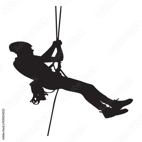 Silhouette of a person rappelling down a rope wearing a helmet and harness engaged in an extreme sport or outdoor adventure activity