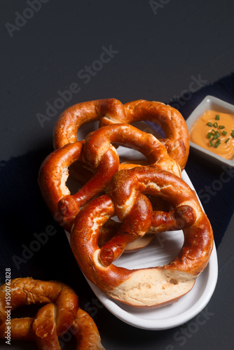 Food concept soft pretzel on black background with copy space