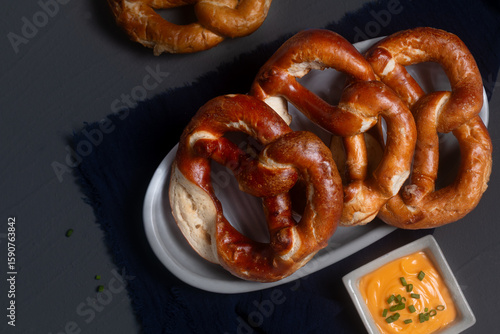 Food concept soft pretzel on black background with copy space