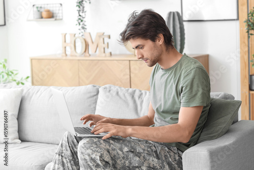 Young male soldier with lap...
