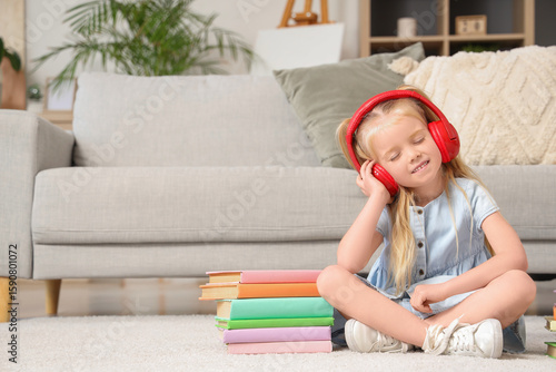 Cute little girl in headpho...