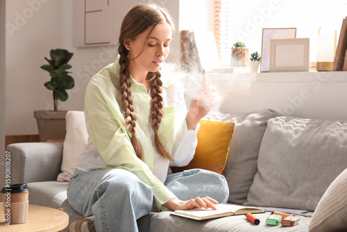 Young woman smoking disposa...