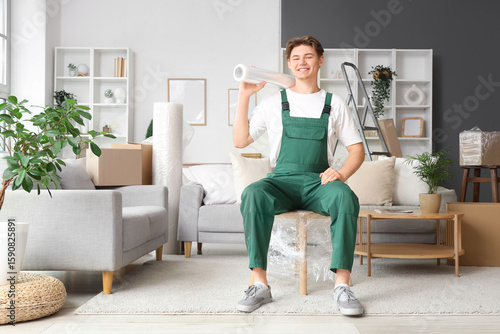 Male worker with roll of st...