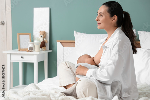Young woman breastfeeding h...
