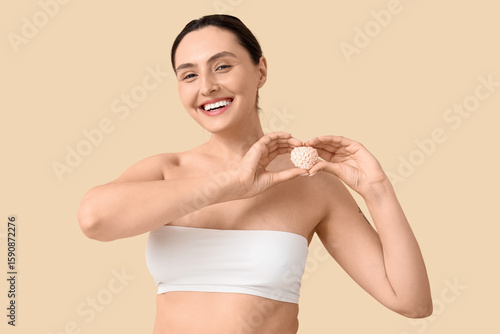 Young woman with bath bomb ...