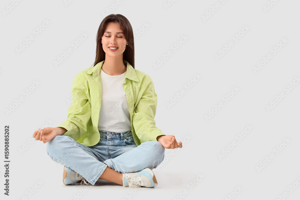 Smiling young woman meditating on white background Smiling young woman meditating on white background