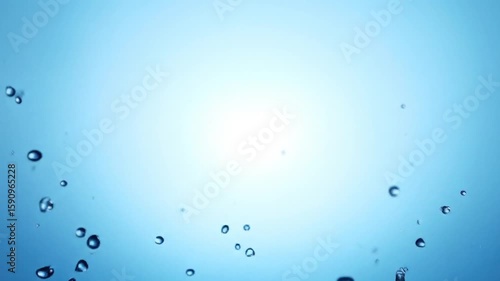 Wallpaper Mural A splash of liquid water erupts upwards. Droplets and a burst spread against a blue gradient background Torontodigital.ca