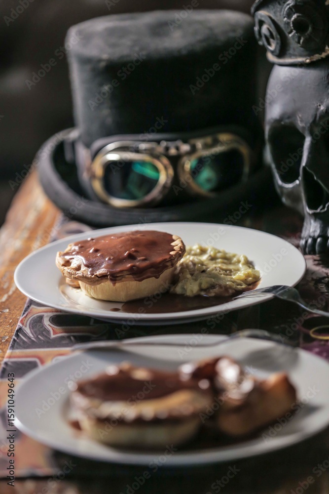 Fototapeta premium Steampunk-Themed Meat Pie with Mashed Potatoes and Skull Deco