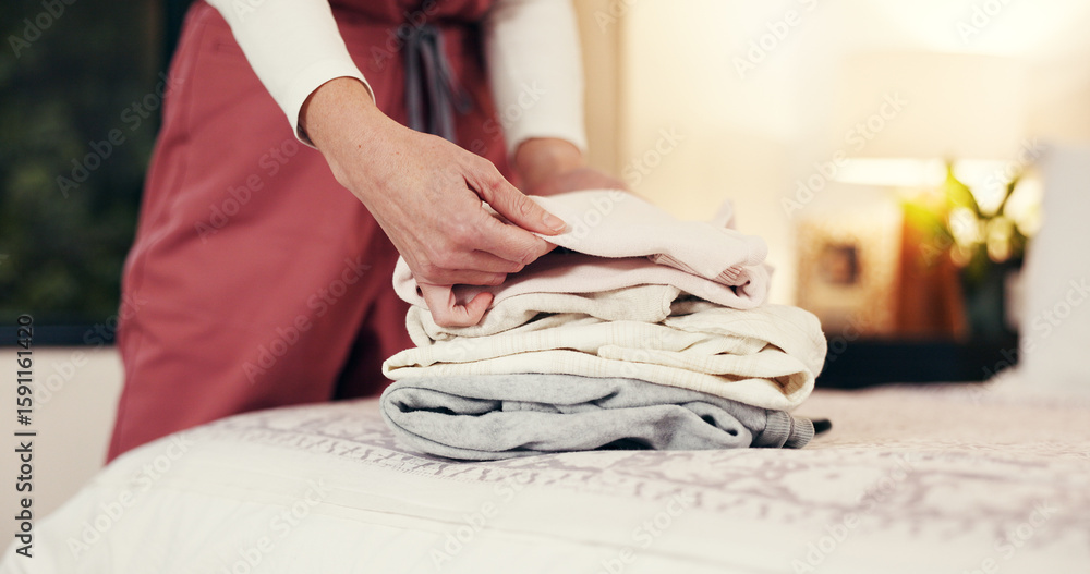 Fototapeta premium Hands folding laundry, bed and house for hygiene routine, services and nurse in bedroom. Person, caregiver and packing clean clothes with garments, fabric or assisted living career at retirement home