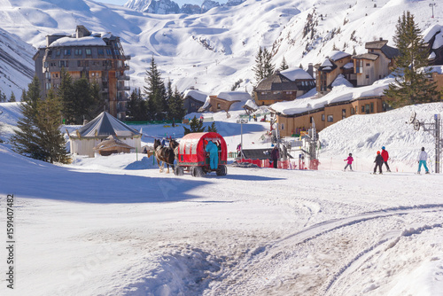 Horse drawn sleigh transporting guests through the car free resort of Avoriaz in the French Alps