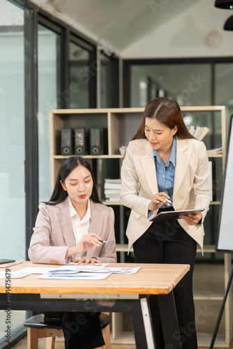 Asian business woman working and talking at the office	