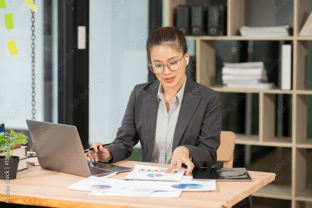 Asian businesswoman working on laptop at office Asian businesswoman working on laptop at office