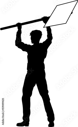 Protestor or demonstrator at a demonstration march, picket line or strike protest rally in silhouette. Holding up a banner or picket sign board placard.