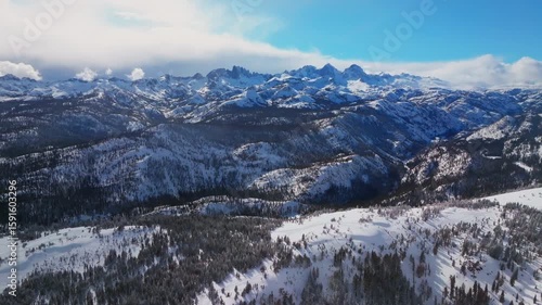 Winter Spring Mammoth Mountain ski resort California Hemlocks Ritter Range Sierra Nevadas Minarets Summit vista sunny blue sky snowy clouds over jagged peaks Inyo Sierras National Forest backwards
