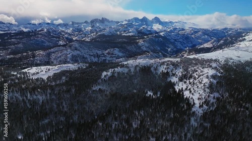 Mammoth Mountain ski resort California Hemlocks panorama Winter Spring Minarets Summit vista Ritter Sierra Nevada range sunny blue sky snowy clouds jagged peaks Inyo Sierras National Forest forward