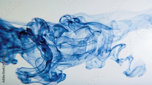 blue ink in water on white background, dreamy slow motion abstract visual