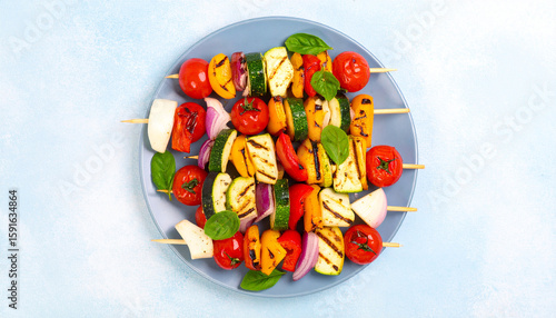 Grilled Vegetable Skewers: Colorful grilled vegetable skewers, vibrant with the flavors of summer, arranged on a slate gray plate.  Each skewer features juicy cherry tomatoes, tender zucchini.