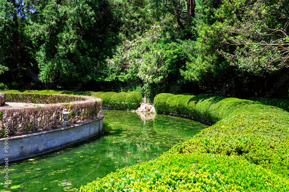 Fototapeta premium Isola dei Conigli - Rabbits Island.From the sweet face of the cherub, water shoots out of the fountain. located inside Villa di Barbarigo in Valsanzibio Galzignano Terme, Padua - Italy.