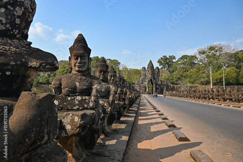 Stone guardian statues at the entrance bridge to the South Gate of Angkor Thom, ancient Khmer city in Cambodia