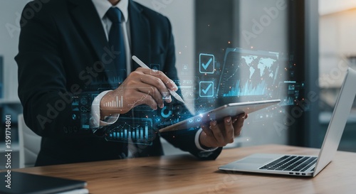 Businessman analyzing global data with digital tablet and pen, futuristic interface