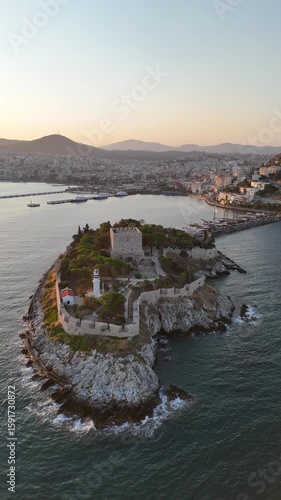 Aerial view of Guvercinada Island (Pigeon Island) with scenic castle at Kusadasi, Turkey. The large resort town is a popular tourist destination in Turkey.