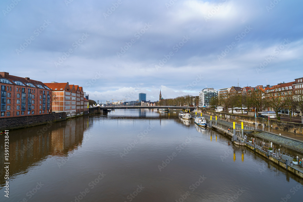Obraz premium Bremen’s skyline shines after the storm, as seen from the Weser Bridge, Germany